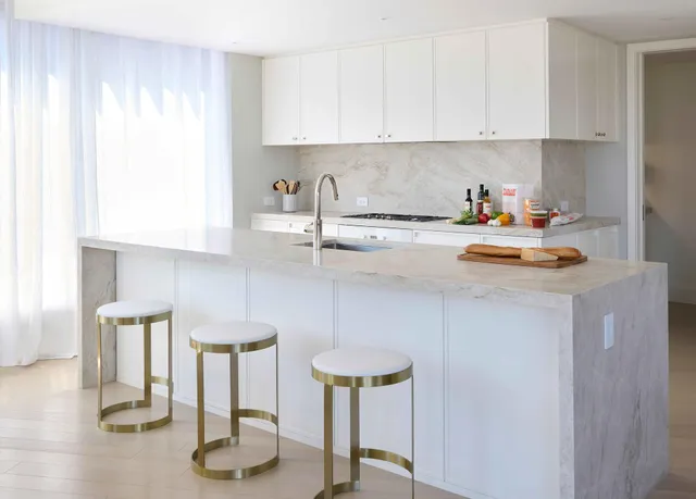 a kitchen with a sink cabinets and appliances