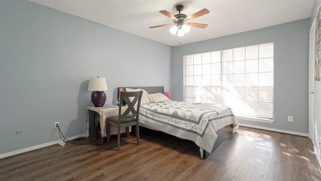 12921 Abrams Road, Unit 505 Dallas, TX 75243 - Photo 15 of 24 Bedroom with dark wood-style floors, ceiling fan, and a textured ceiling