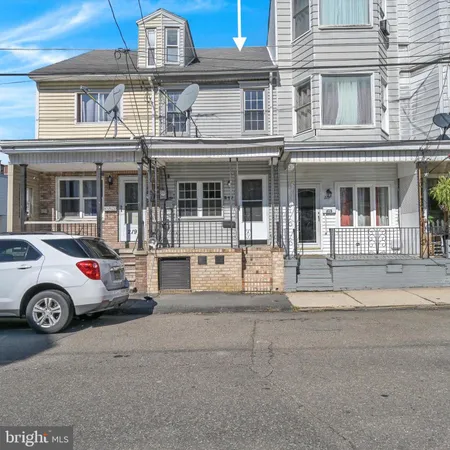 front view of a house with a cars parked in front of it