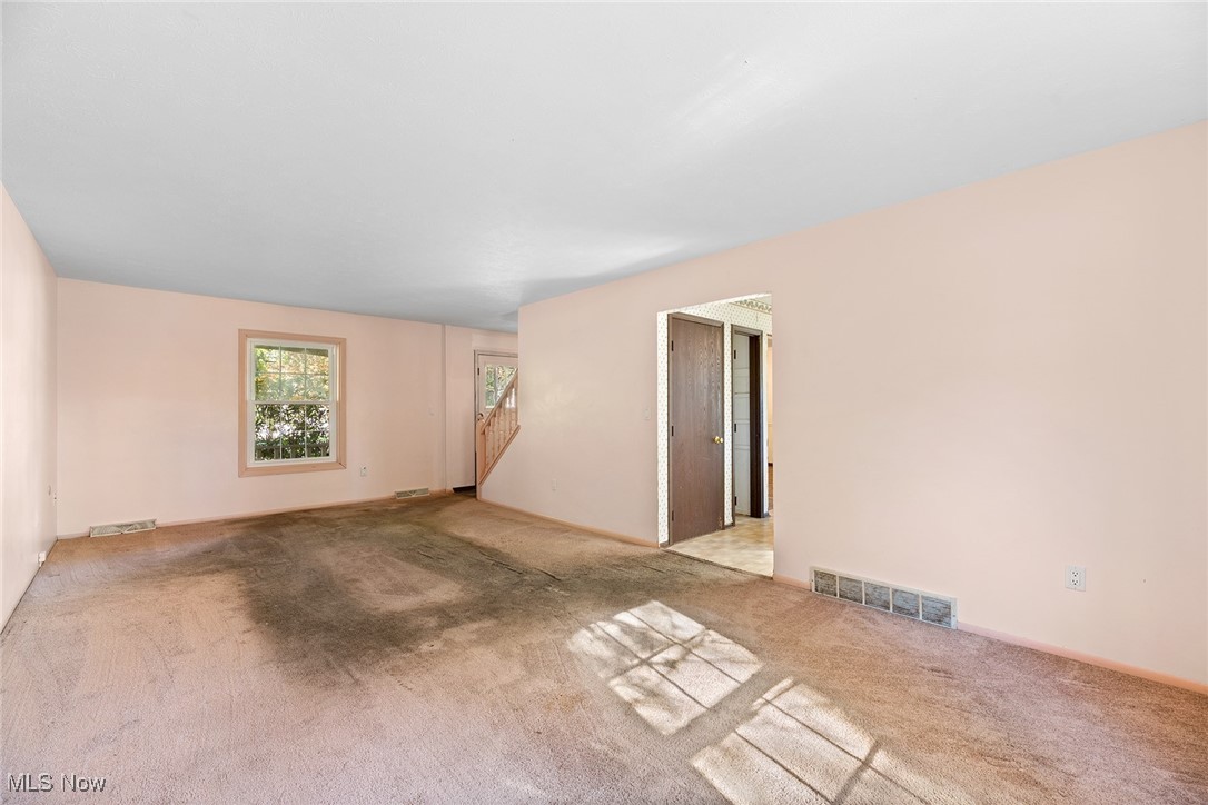3550 Boston Road Brunswick, OH 44212 - Photo 15 of 37 Carpeted spare room featuring baseboards and stairway