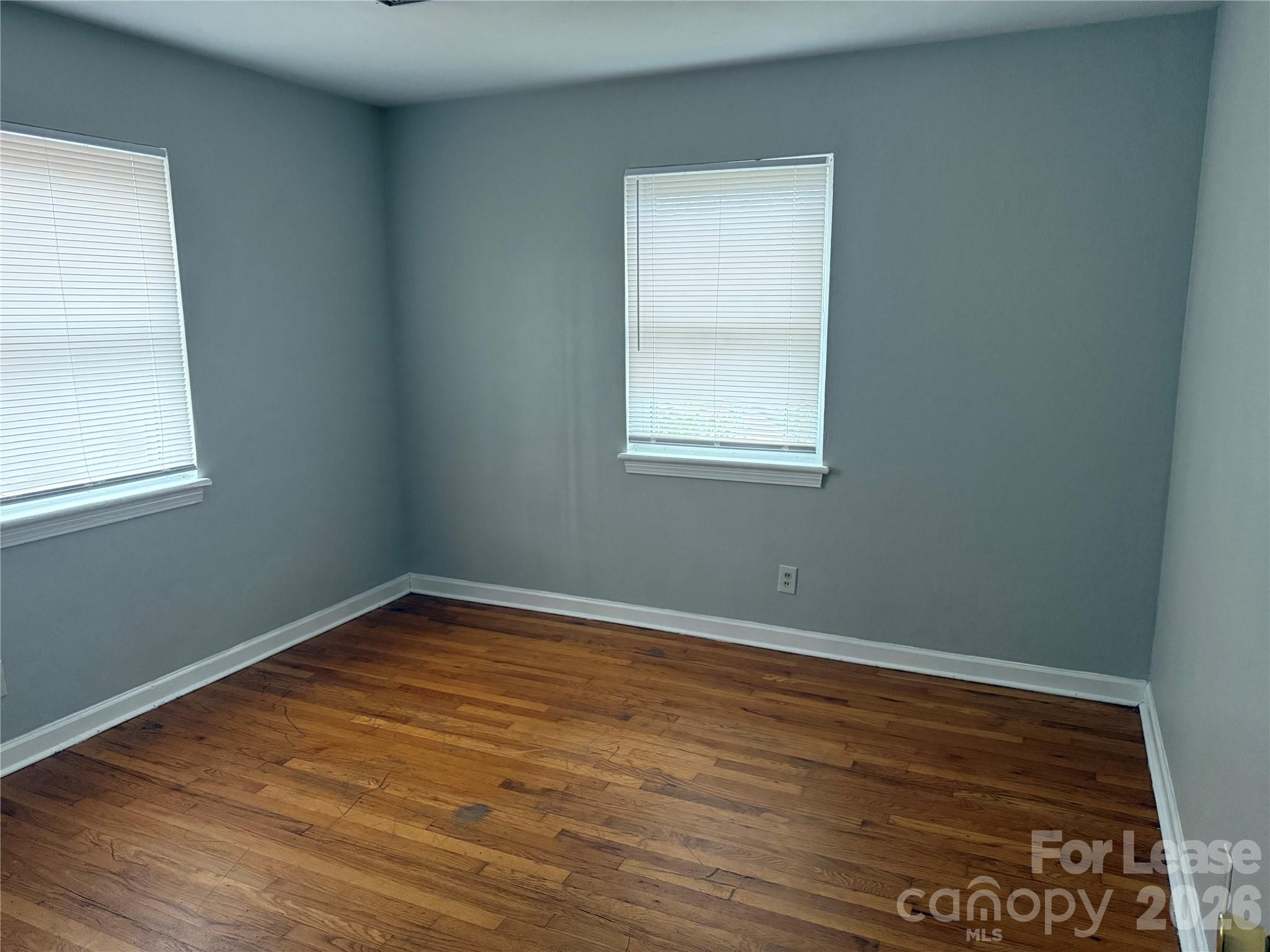 833 4th Avenue Southwest Hickory, NC 28602 - Photo 5 of 9 an empty room with wooden floor and windows