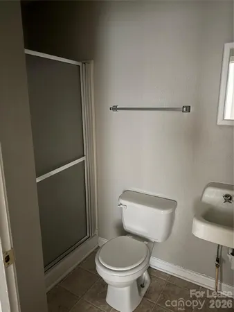 a white toilet sitting next to a bathroom sink
