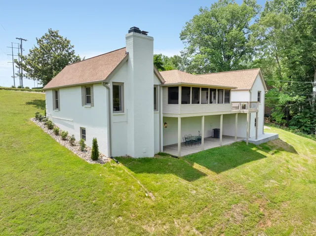 a view of a house with yard and sitting area