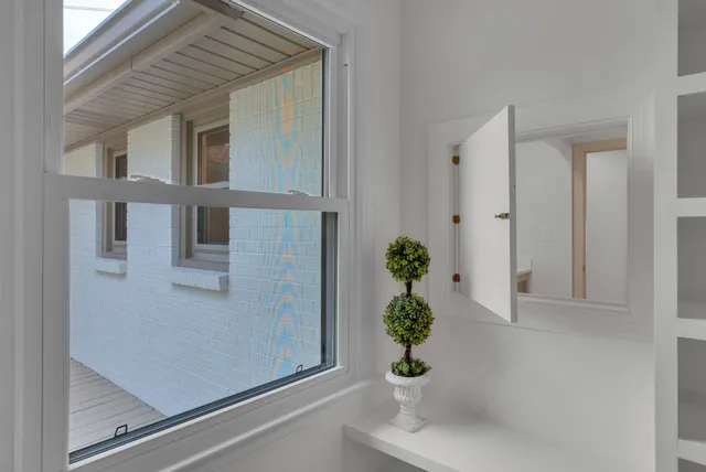 a bathroom with a granite countertop sink a mirror and shower