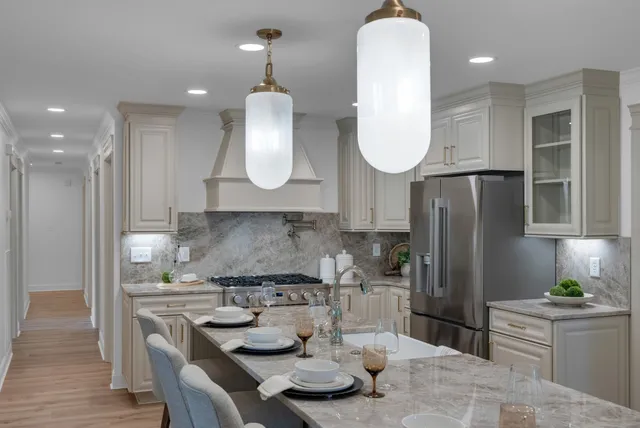 a dining room with wooden floor a chandelier a wooden table and chairs