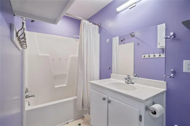 a bathroom with a bath tub sink mirror and vanity
