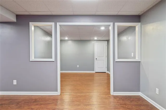 a view of a hallway with wooden floor