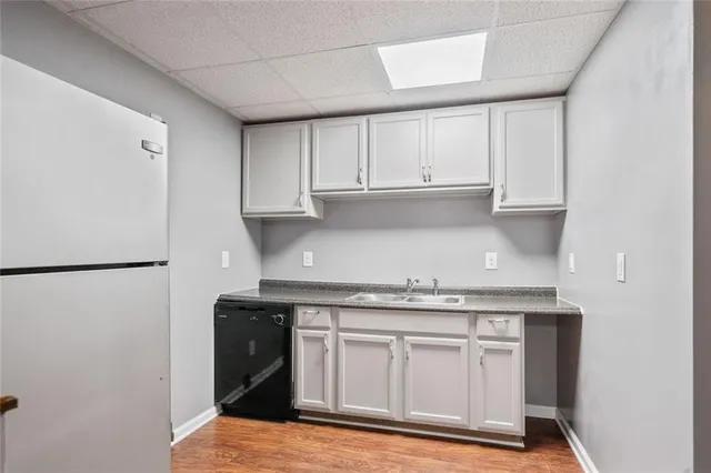 a kitchen with stainless steel appliances granite countertop a refrigerator sink and cabinets