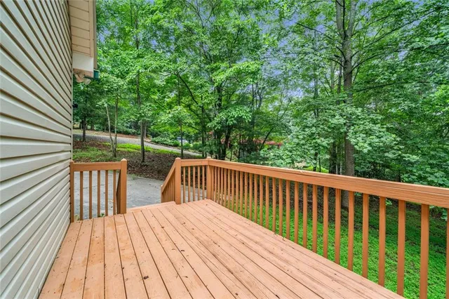 a view of balcony with wooden floor and fence