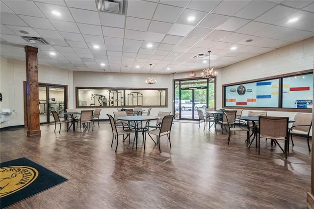 a dining room with furniture window and wooden floor