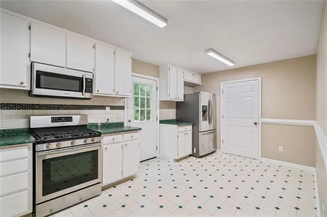 a kitchen with a refrigerator stove and microwave