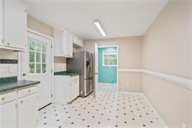 a kitchen with a refrigerator and a sink