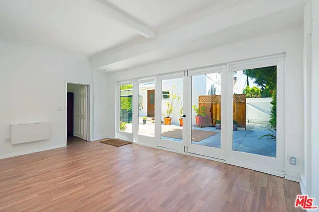 a view of an empty room with glass door and balcony