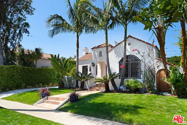 a front view of house with yard and swimming pool