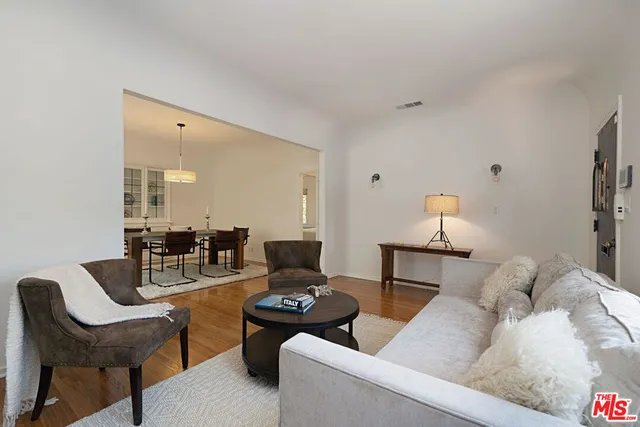 a living room with furniture and a lamp
