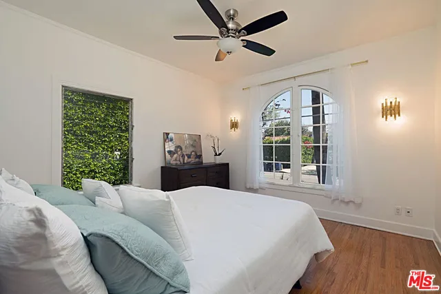 a large bedroom with a large bed and a large window