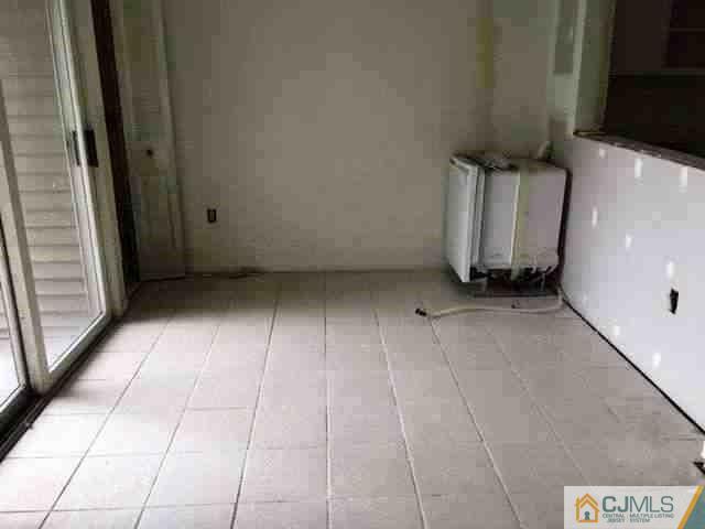 710 Edpas Road, Unit 710 New Brunswick, NJ 08901 - Photo 4 of 6 a view of an empty room with a window