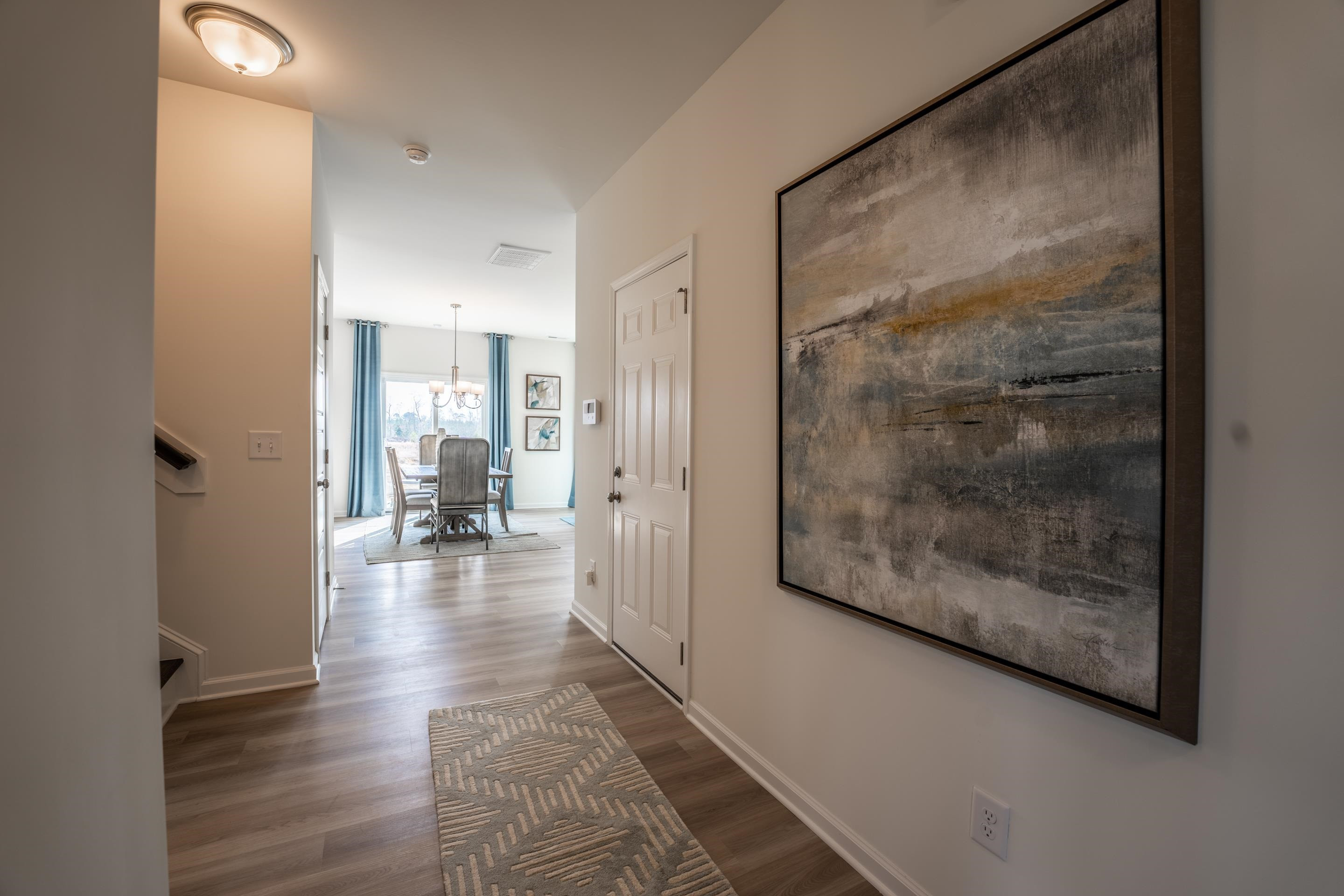 6517 Winter Spring Drive Wake Forest, NC 27587 - Photo 2 of 40 a view of a hallway with wooden floor and a living room