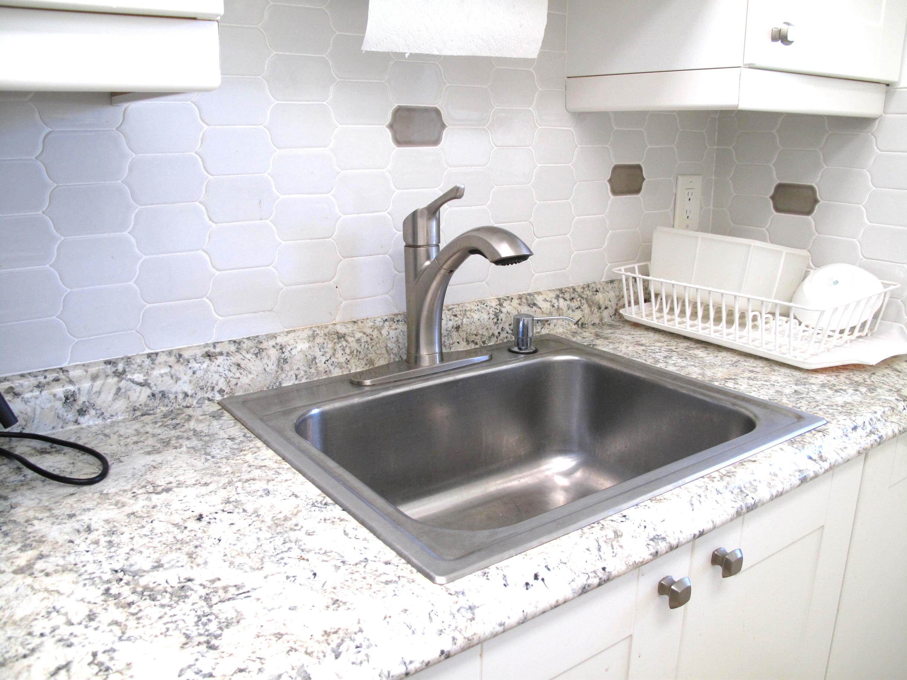 892 North High Point Boulevard North, Unit D Delray Beach, FL 33445 - Photo 14 of 44 a close view of sink and tap