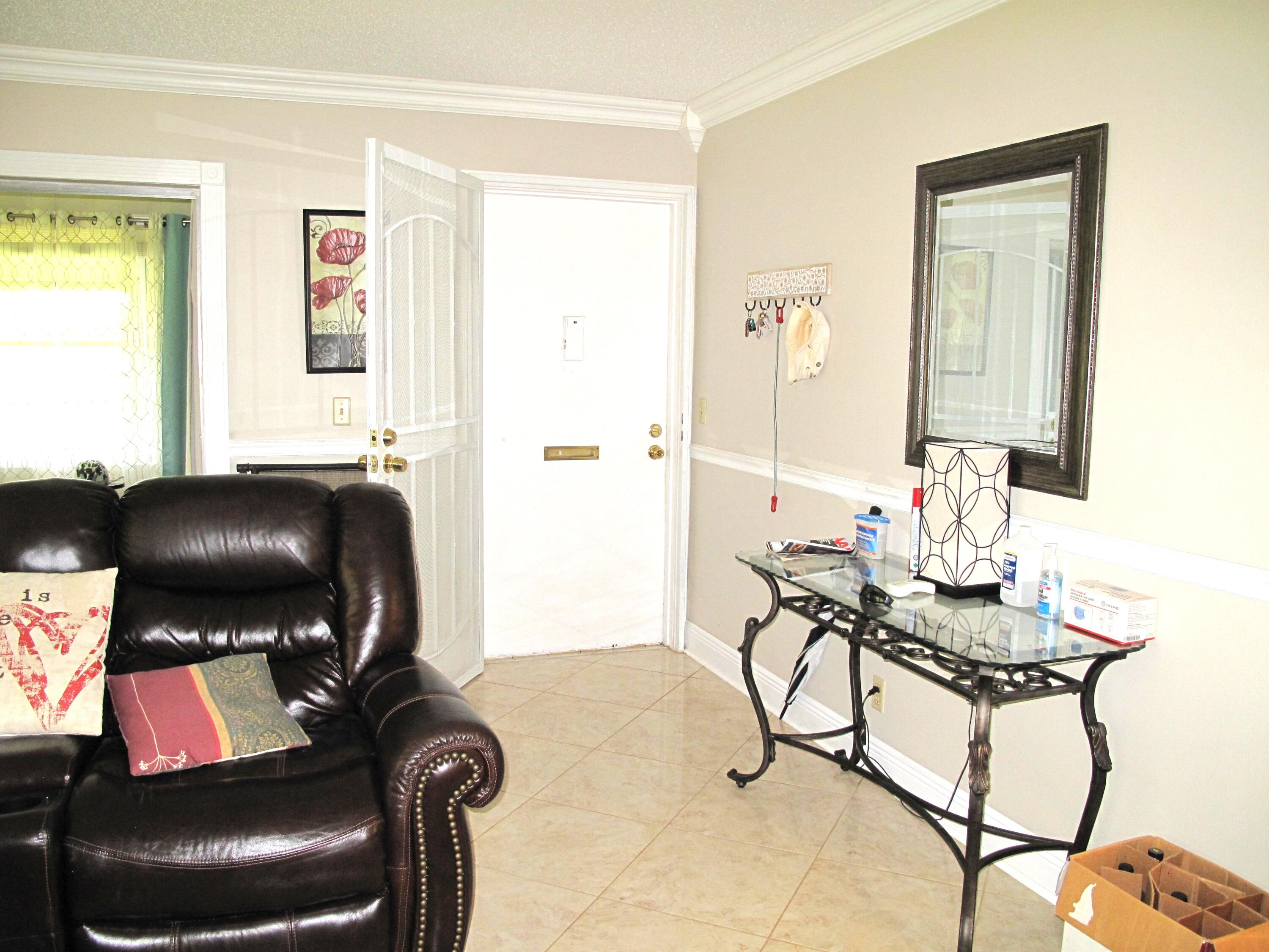 892 North High Point Boulevard North, Unit D Delray Beach, FL 33445 - Photo 16 of 44 a living room with furniture