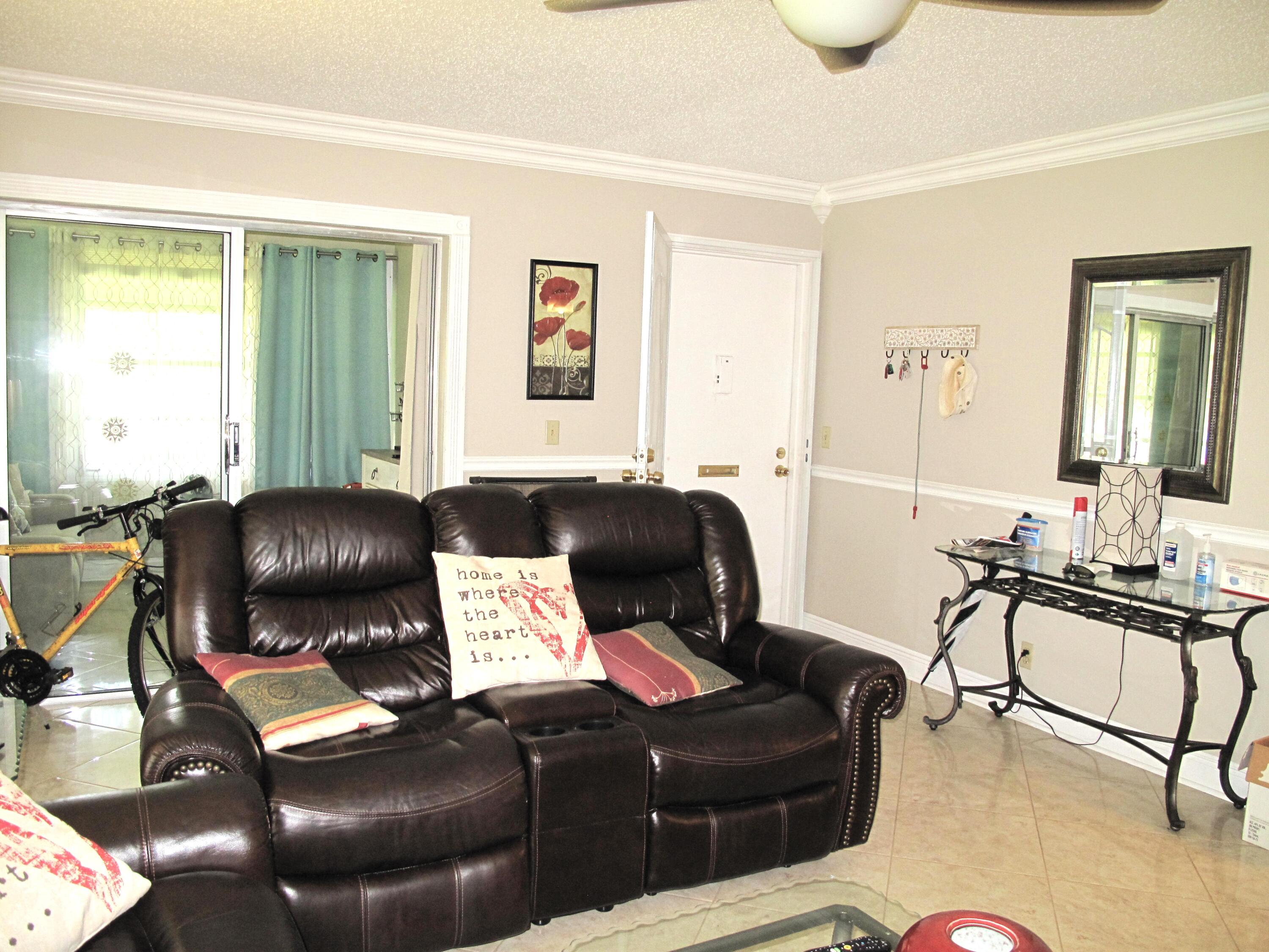 892 North High Point Boulevard North, Unit D Delray Beach, FL 33445 - Photo 17 of 44 a living room with furniture
