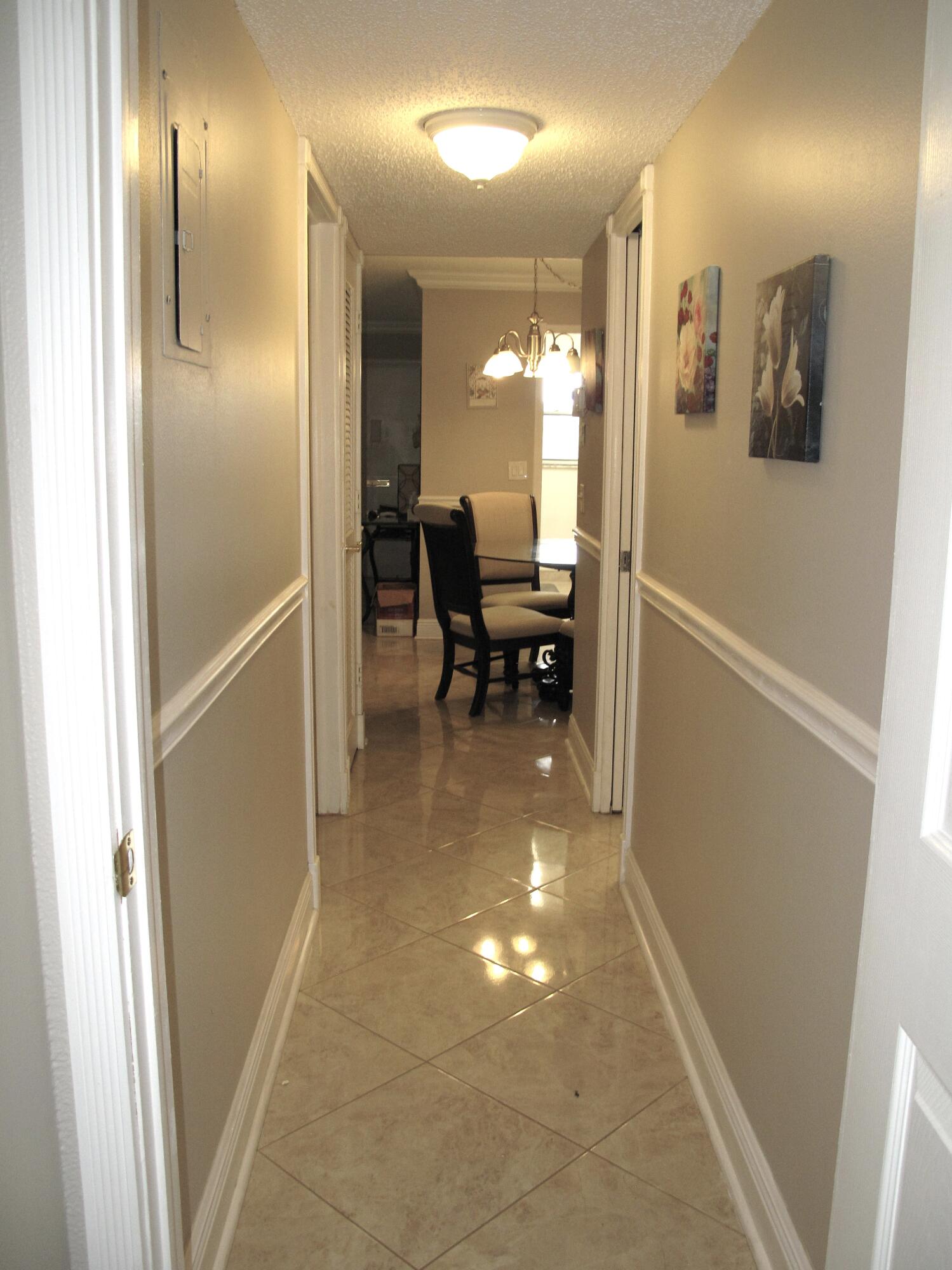 892 North High Point Boulevard North, Unit D Delray Beach, FL 33445 - Photo 20 of 44 a view of a hallway with dining area and glass door