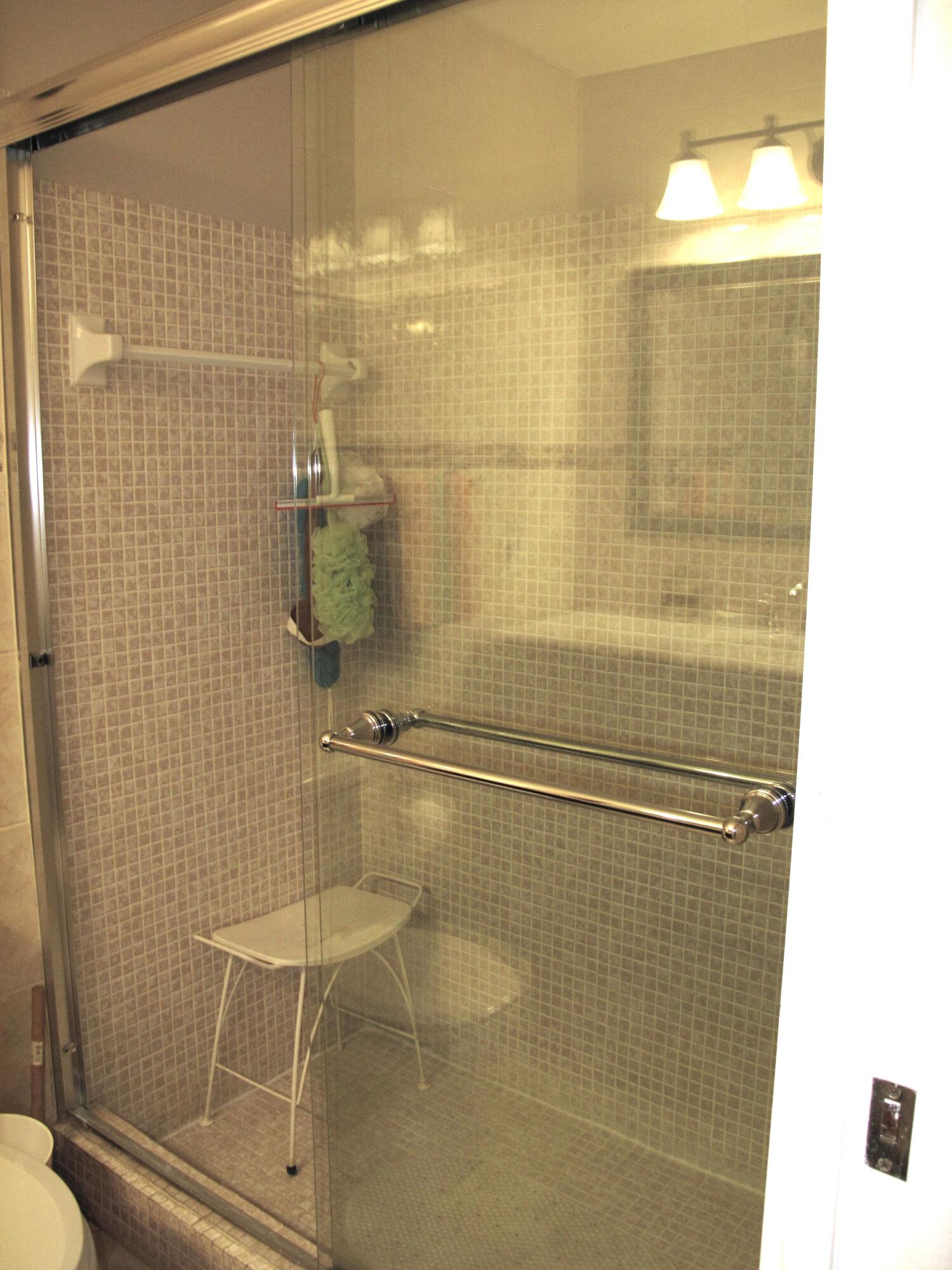 892 North High Point Boulevard North, Unit D Delray Beach, FL 33445 - Photo 21 of 44 a bathroom with a shower