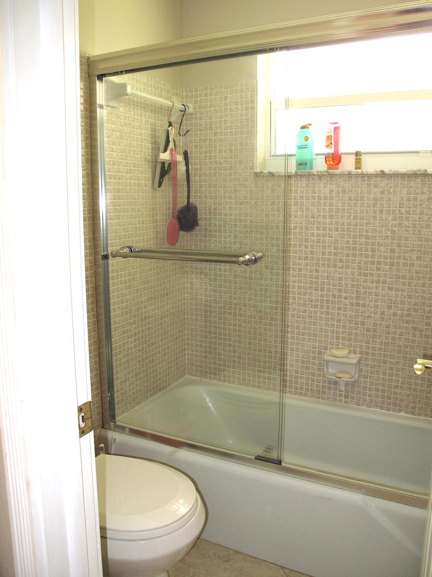 892 North High Point Boulevard North, Unit D Delray Beach, FL 33445 - Photo 26 of 44 a bathroom with a toilet and a shower