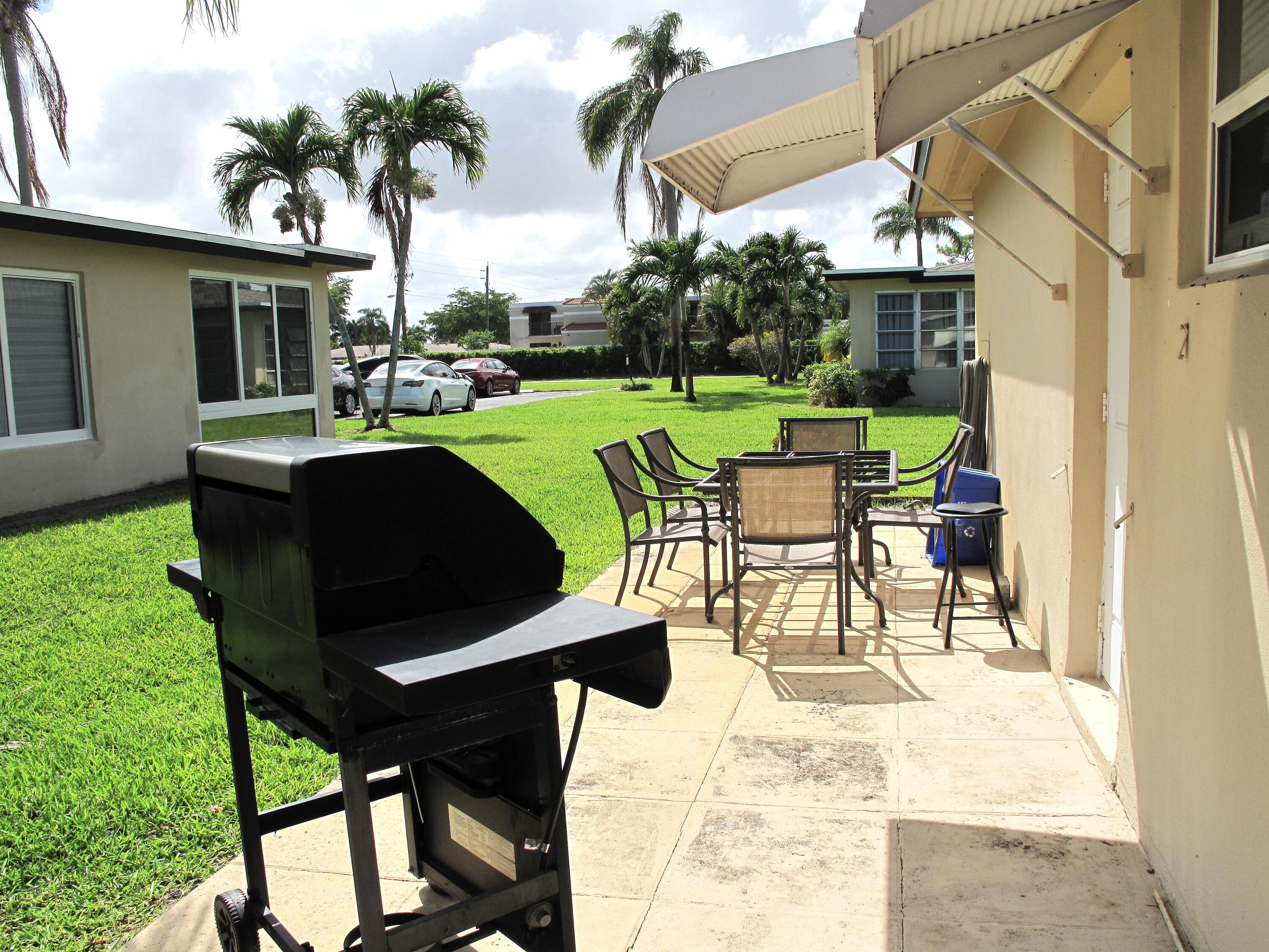 892 North High Point Boulevard North, Unit D Delray Beach, FL 33445 - Photo 32 of 44 a building outdoor space with patio furniture