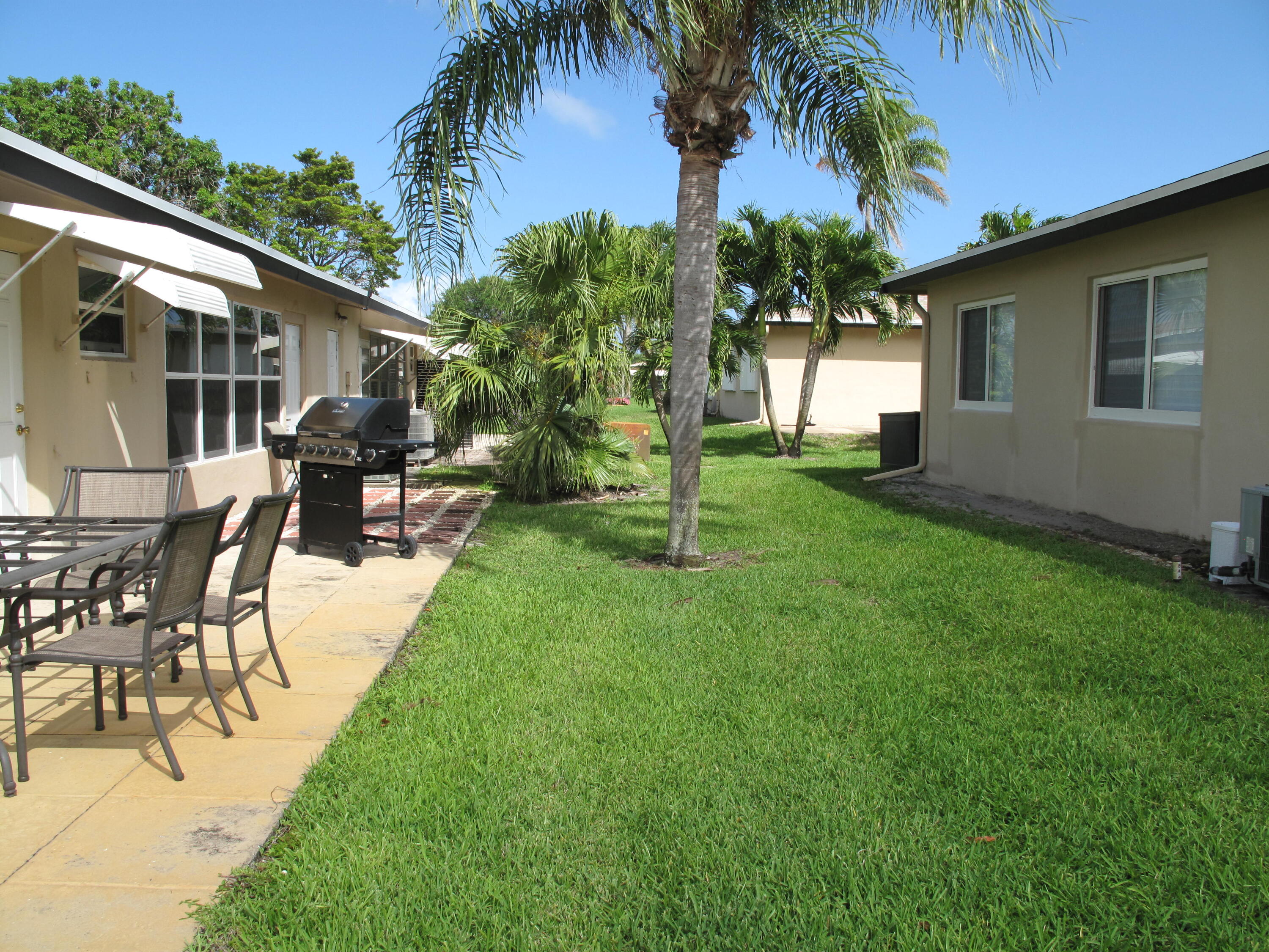 892 North High Point Boulevard North, Unit D Delray Beach, FL 33445 - Photo 33 of 44 a view of a backyard with a patio