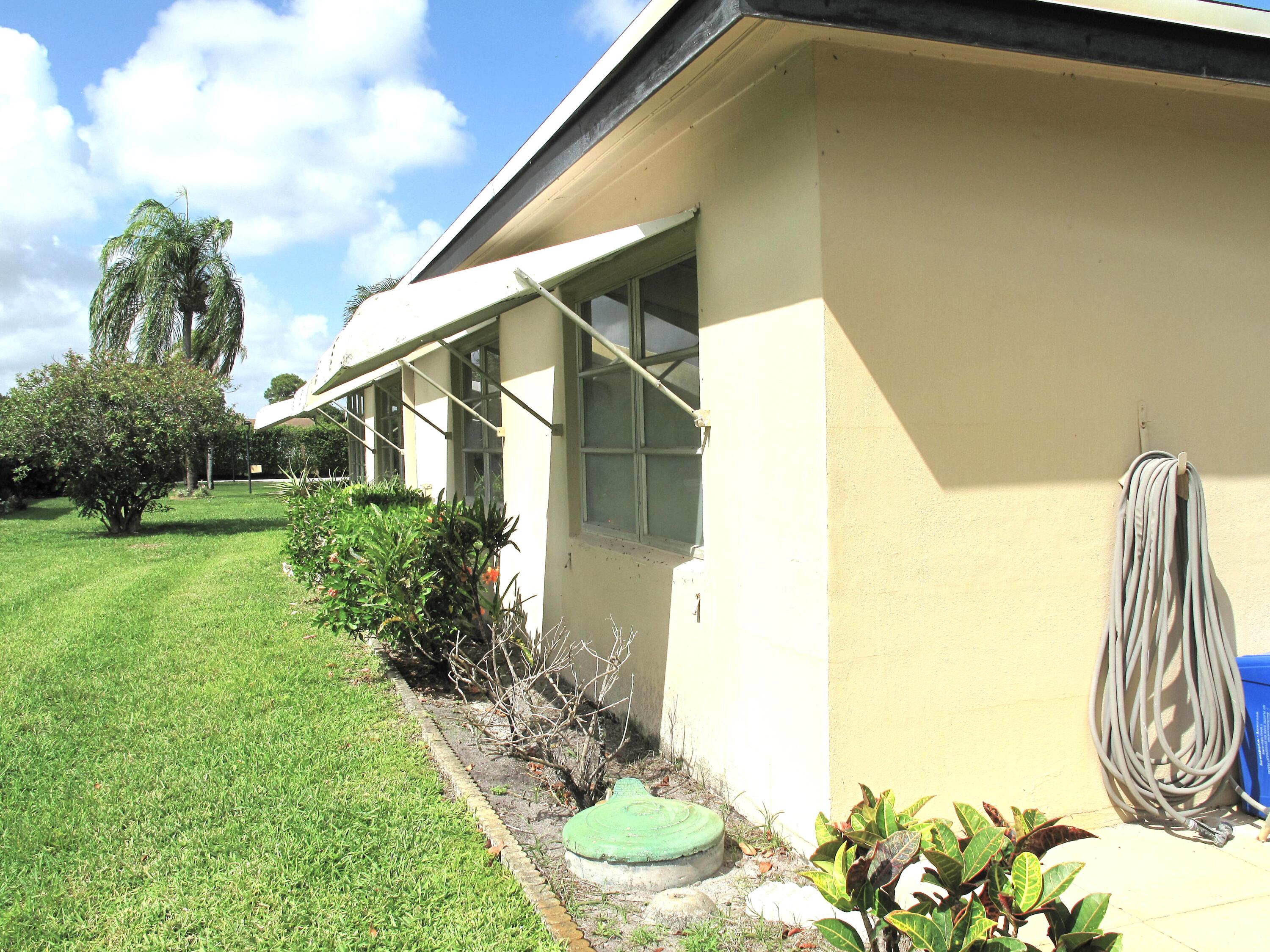 892 North High Point Boulevard North, Unit D Delray Beach, FL 33445 - Photo 34 of 44 a house view with a backyard