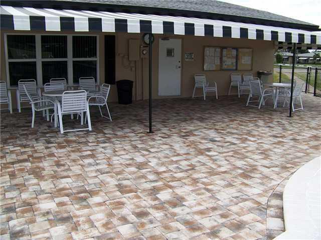 892 North High Point Boulevard North, Unit D Delray Beach, FL 33445 - Photo 39 of 44 a outdoor space with a large window