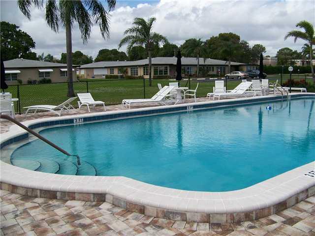 892 North High Point Boulevard North, Unit D Delray Beach, FL 33445 - Photo 40 of 44 a view of a lake with a house