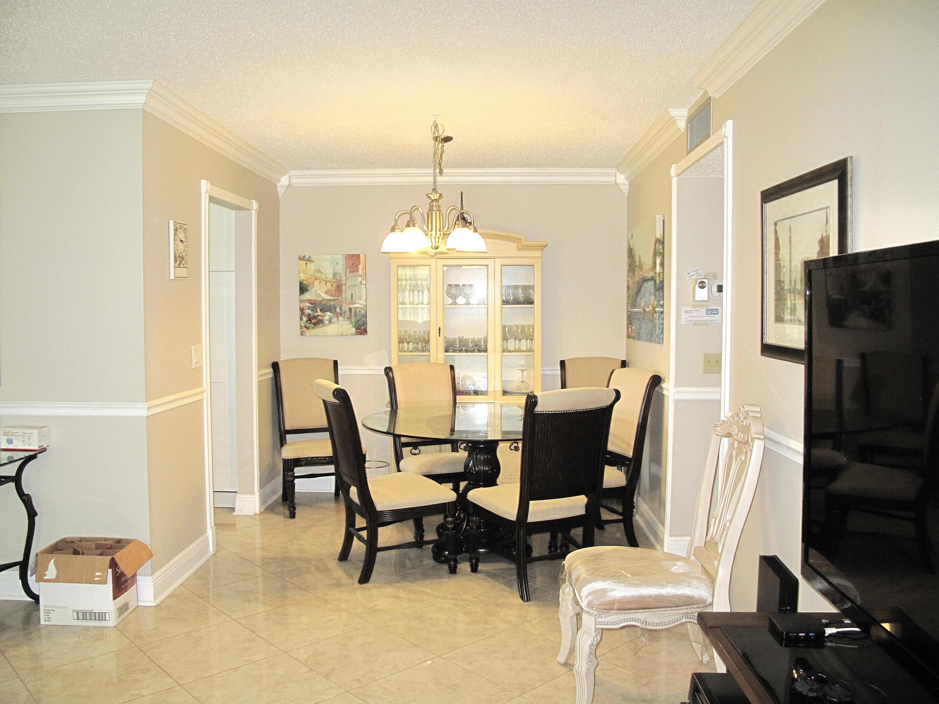 892 North High Point Boulevard North, Unit D Delray Beach, FL 33445 - Photo 6 of 44 a dining room with furniture a chandelier and window