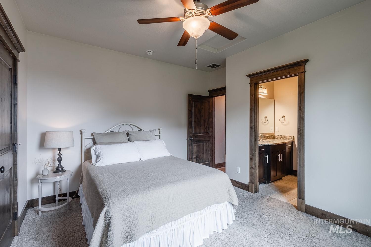8077 Star Pass Ridge Road Nampa, ID 83686 - Photo 27 of 37 Bedroom featuring a ceiling fan with integrated lighting, wood-finish trim and doors, and carpet flooring