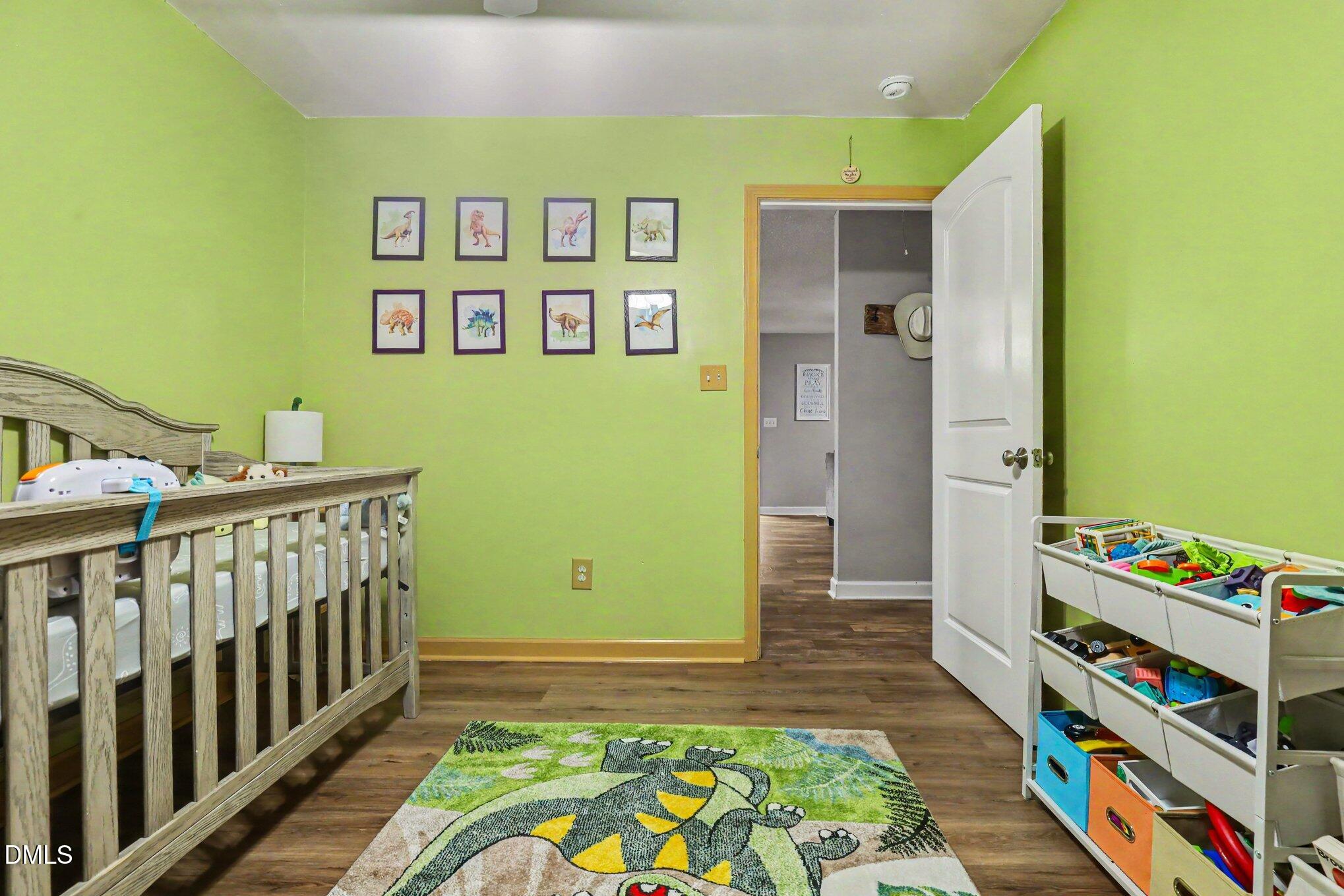977 Stevens Mill Road Goldsboro, NC 27530 - Photo 27 of 31 a bedroom with a bed and a book shelf