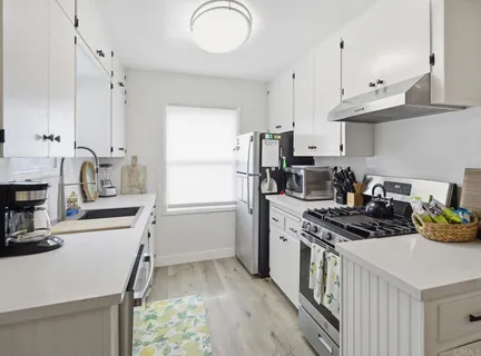 a spacious bedroom with a bed and a potted plant