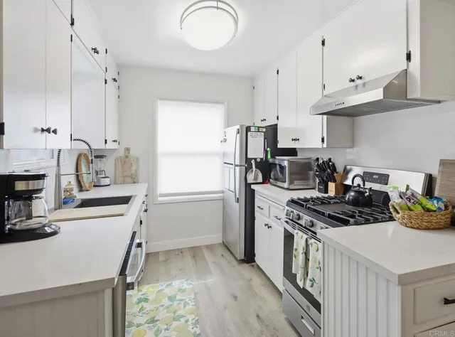 a spacious bedroom with a bed and a potted plant