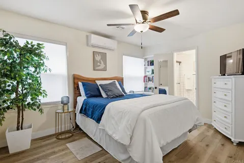 a bathroom with a sink a mirror a toilet and a shower