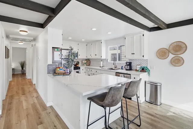 a kitchen with kitchen island a sink stove and refrigerator