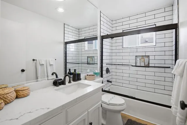 a bedroom with a bed a dresser and a window