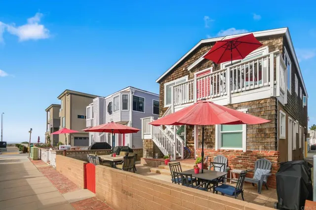 a patio with a table and chairs under an umbrella