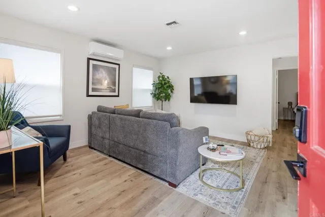 a living room with furniture and a potted plant