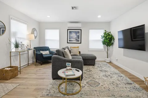 a dining room with furniture and a window