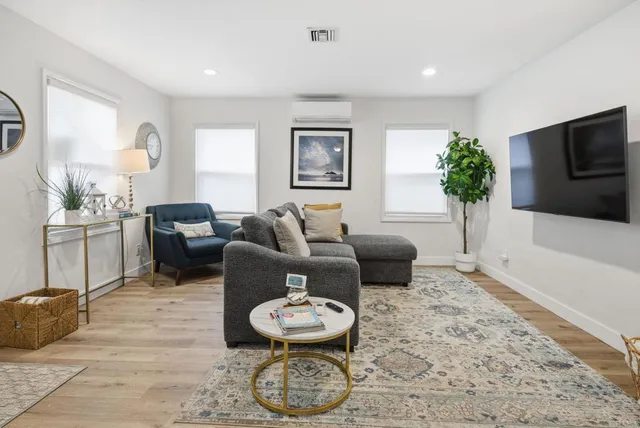 a dining room with furniture and a window