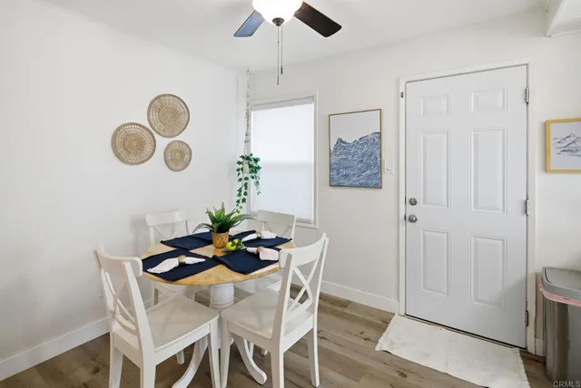 a living room with stainless steel appliances kitchen island furniture and a chandelier
