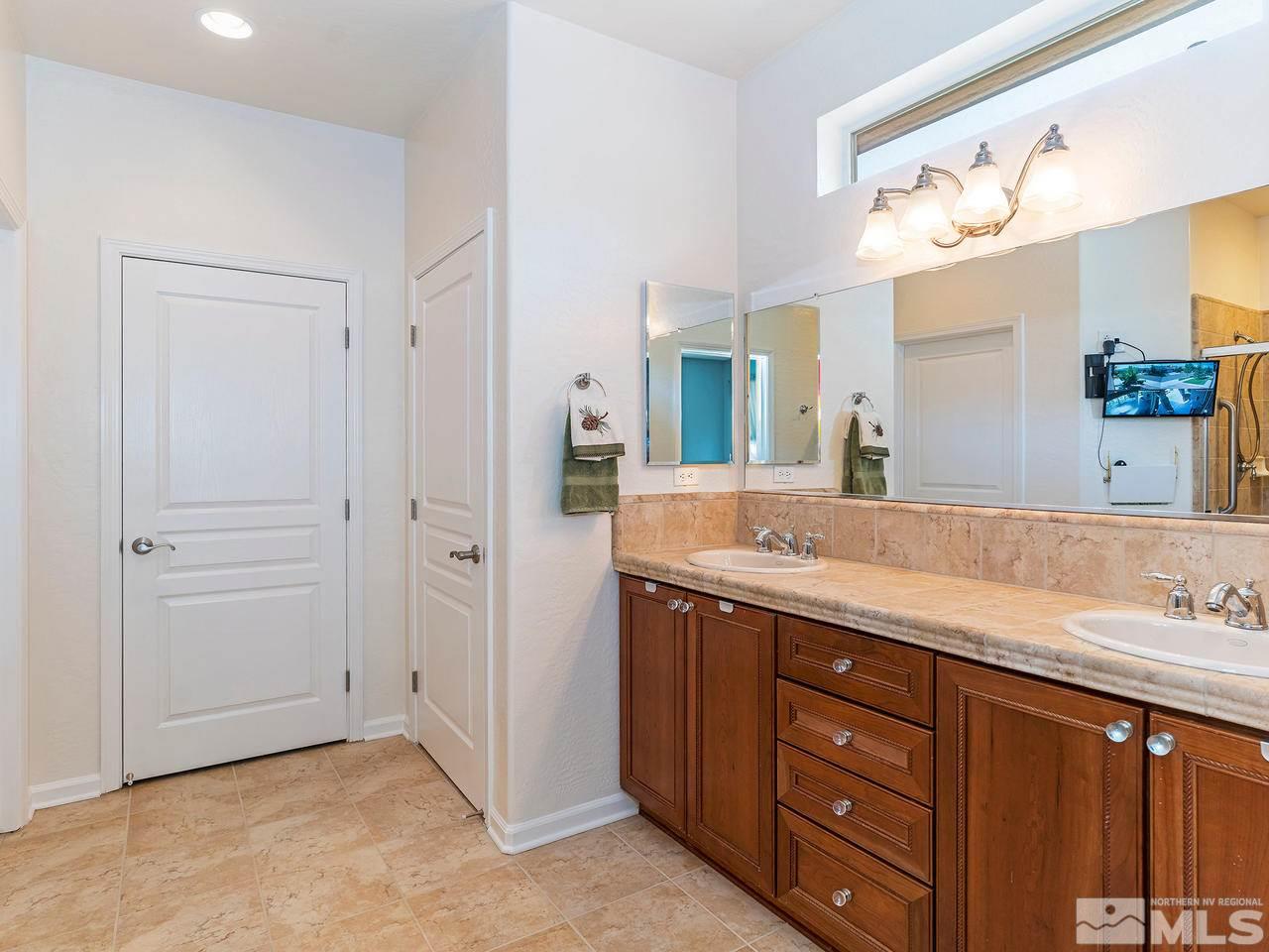 9149 Quilberry Way Reno, NV 89523 - Photo 15 of 20 a spacious bathroom with a granite countertop sink and a mirror
