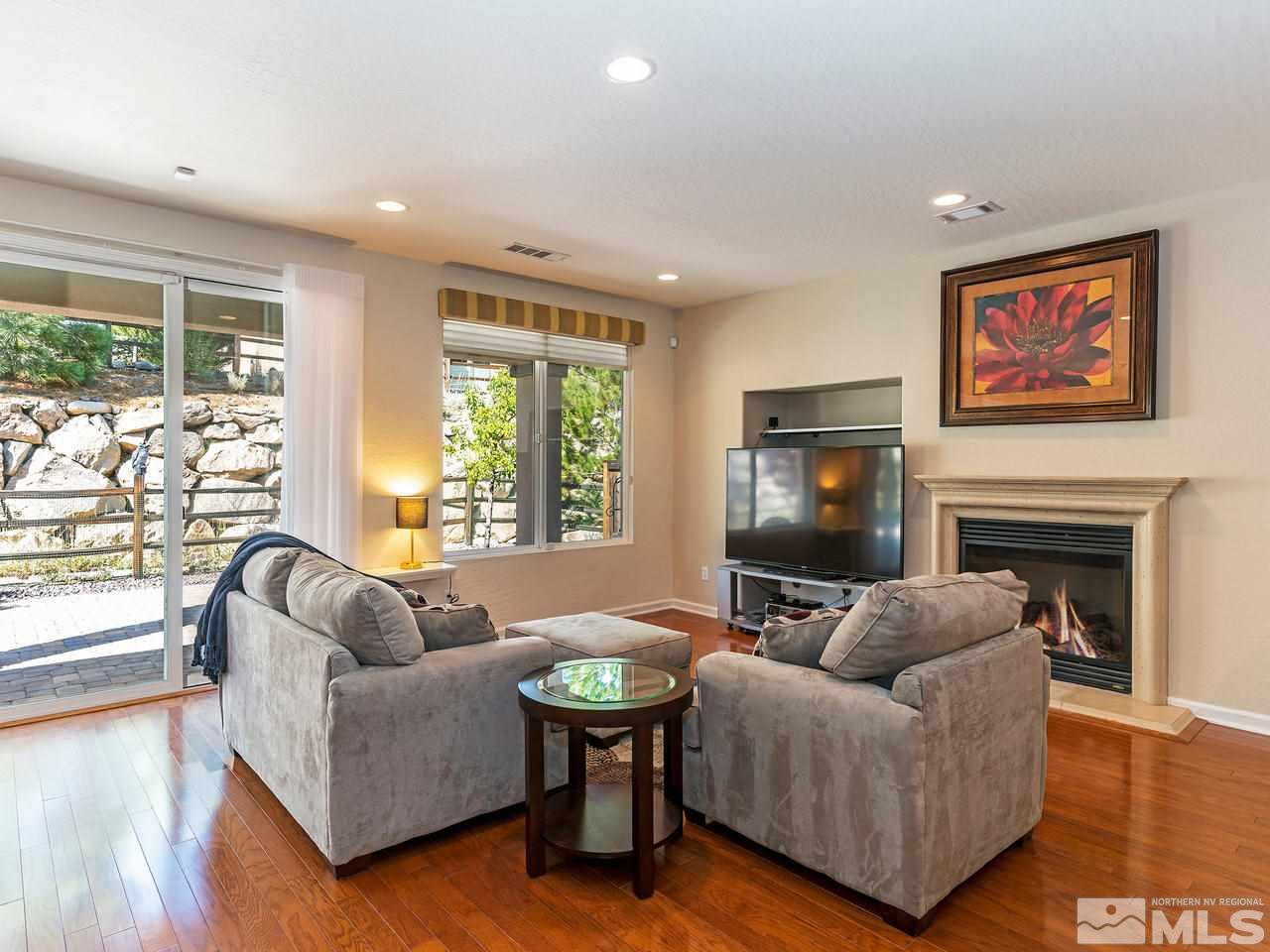 9149 Quilberry Way Reno, NV 89523 - Photo 3 of 20 a living room with furniture a large window and a flat screen tv