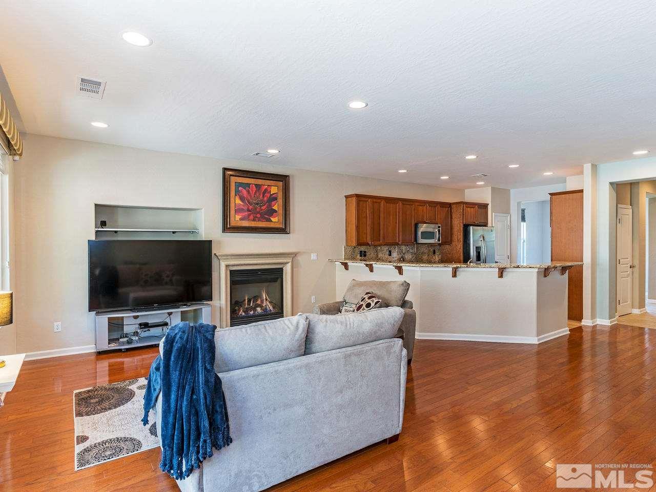 9149 Quilberry Way Reno, NV 89523 - Photo 4 of 20 a living room with fireplace furniture and a flat screen tv