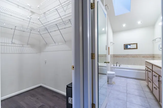 a bathroom with a granite countertop sink a toilet and bathtub